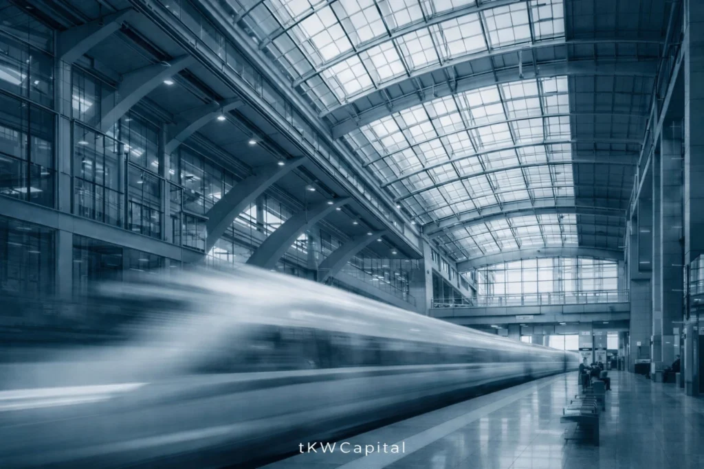 High-speed train moving through a modern glass station, symbolizing momentum, discipline, and long-term capital growth